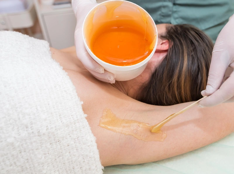 Beautician makes sugar paste depilation armpits beauty salon female aesthetic cosmetology